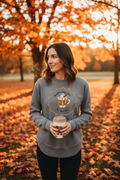 Female model wearing granite grey Pumpkin Spice Latte sweatshirt in fall outdoor setting